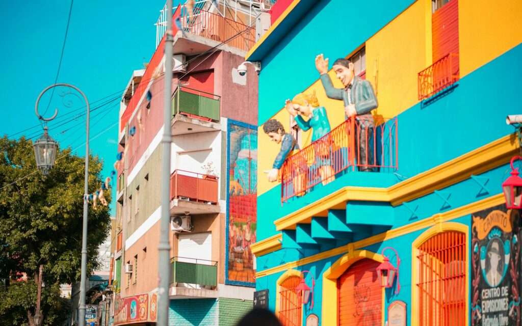 Brightly painted facades and balcony figures on Caminito in La Boca